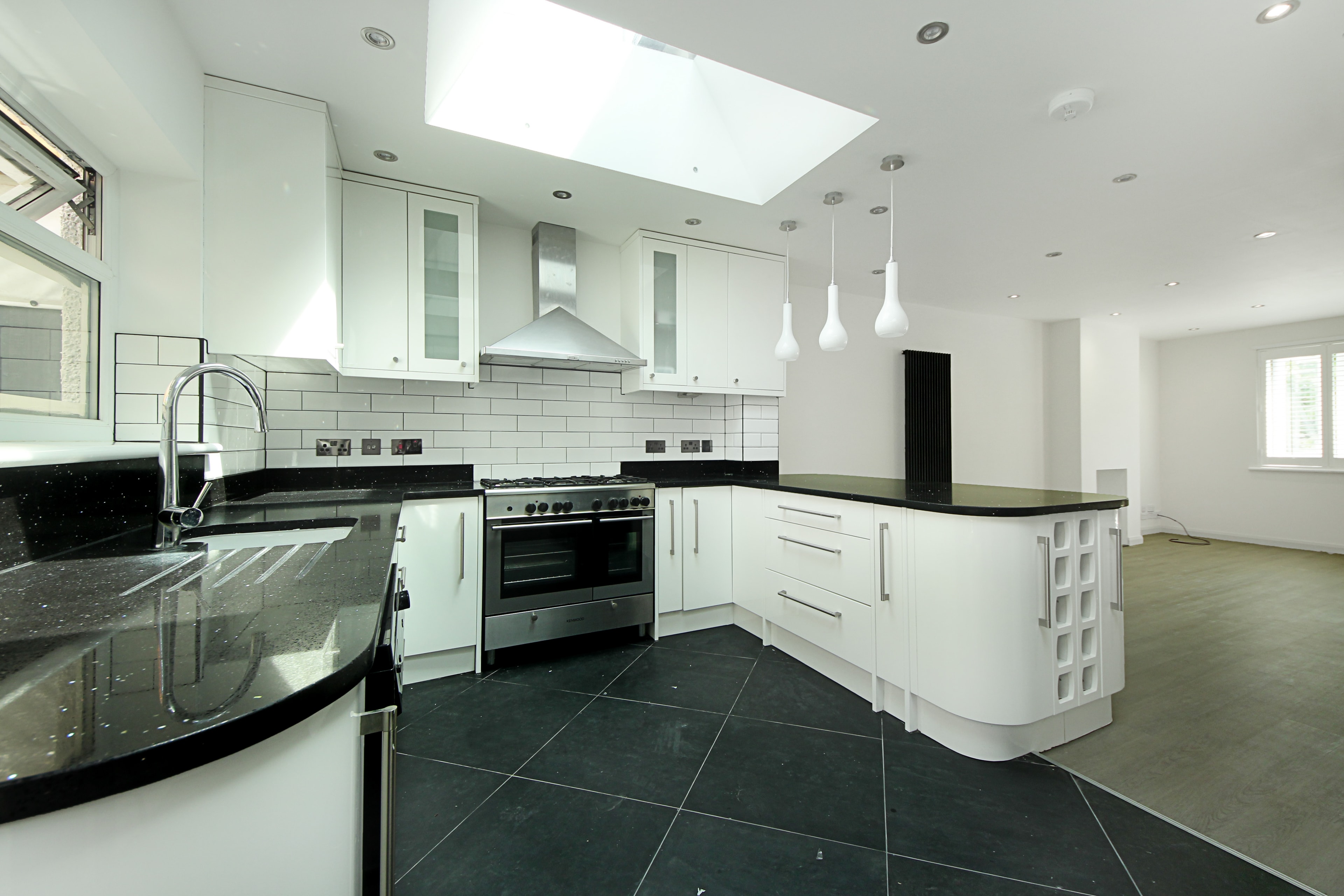 Chilton Avenue 2 — new open-plan kitchen with white units and skylights