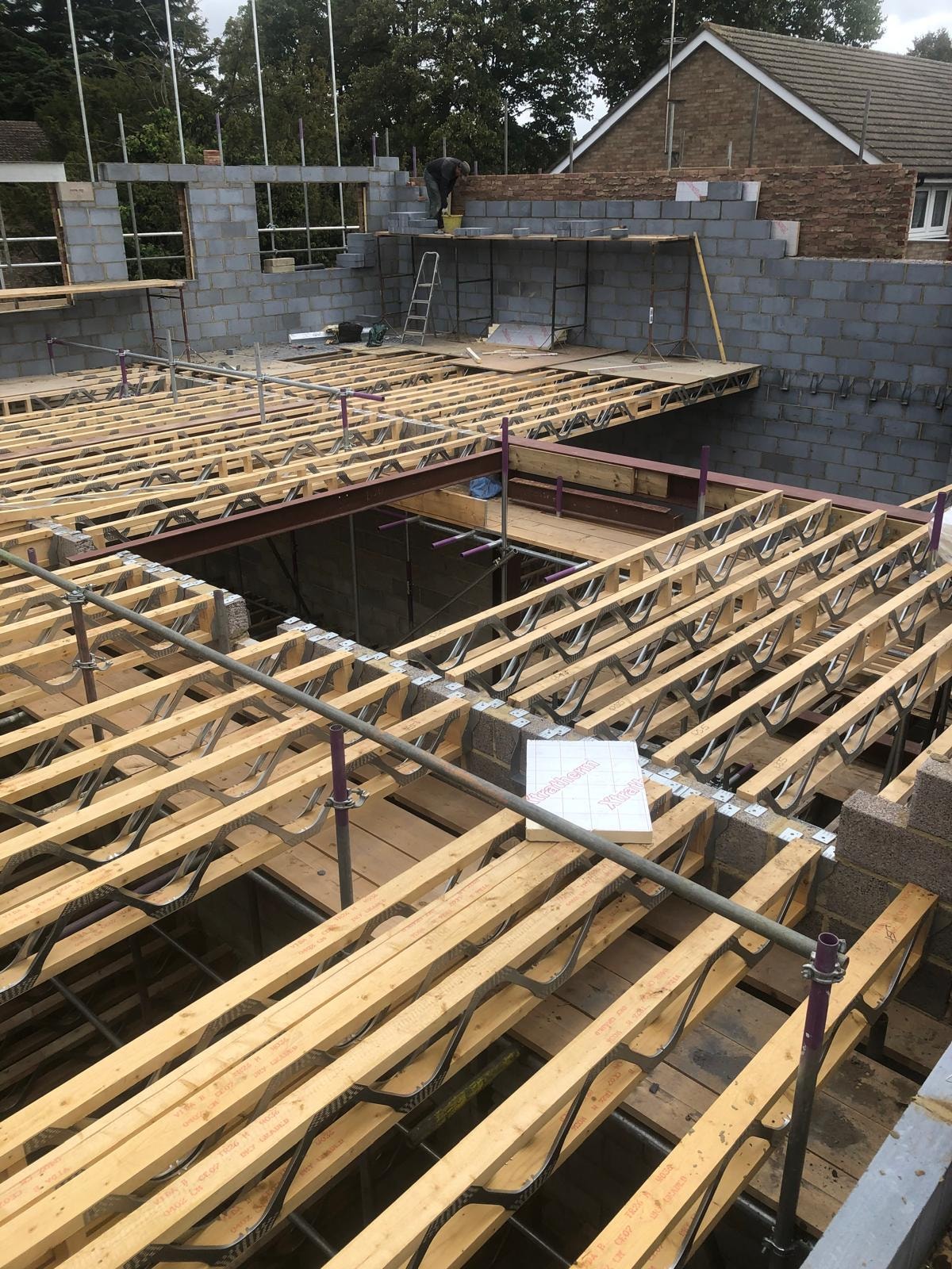 Golden Manor — construction in progress showing timber floor joists and blockwork walls rising
