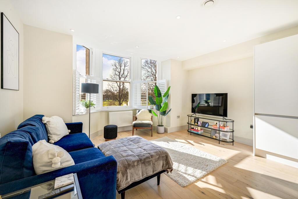 Bright living room with bay window overlooking Ealing Common