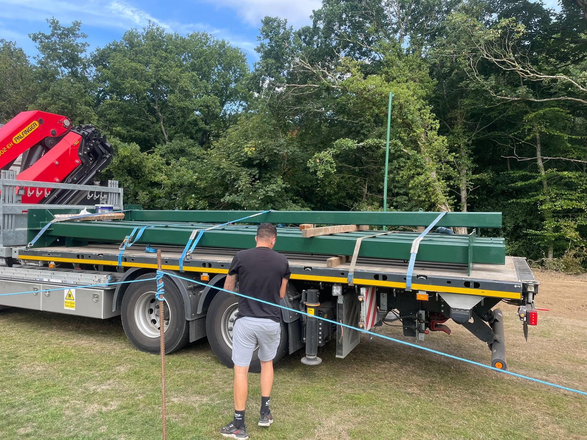 Delivery of green steel net framework on flatbed lorry