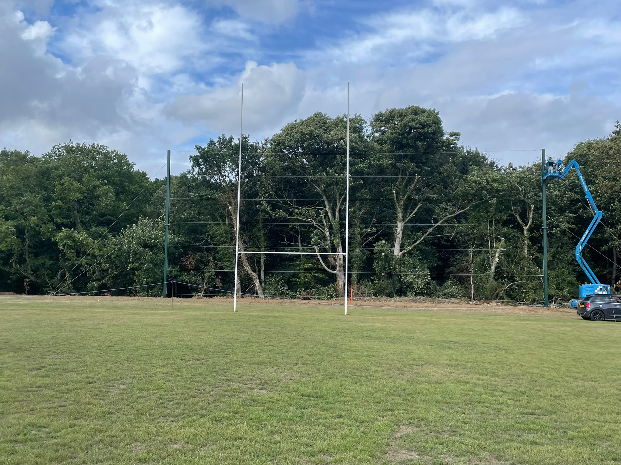 Rugby posts with cherry picker during net installation
