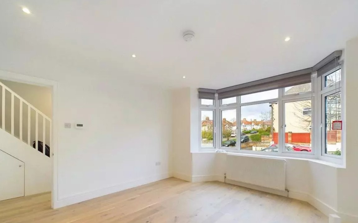 Hillside — completed living room with bay window and oak flooring in new build house
