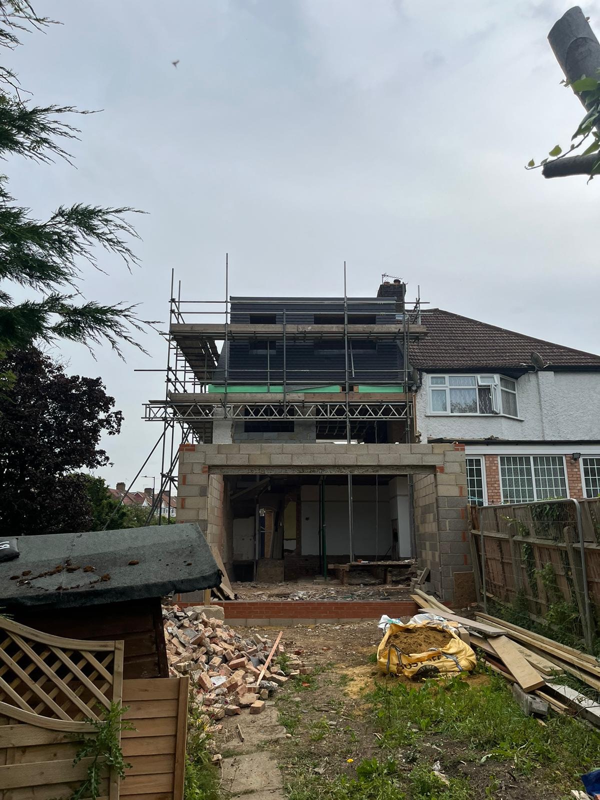 Hillside — rear extension under construction with scaffolding and blockwork