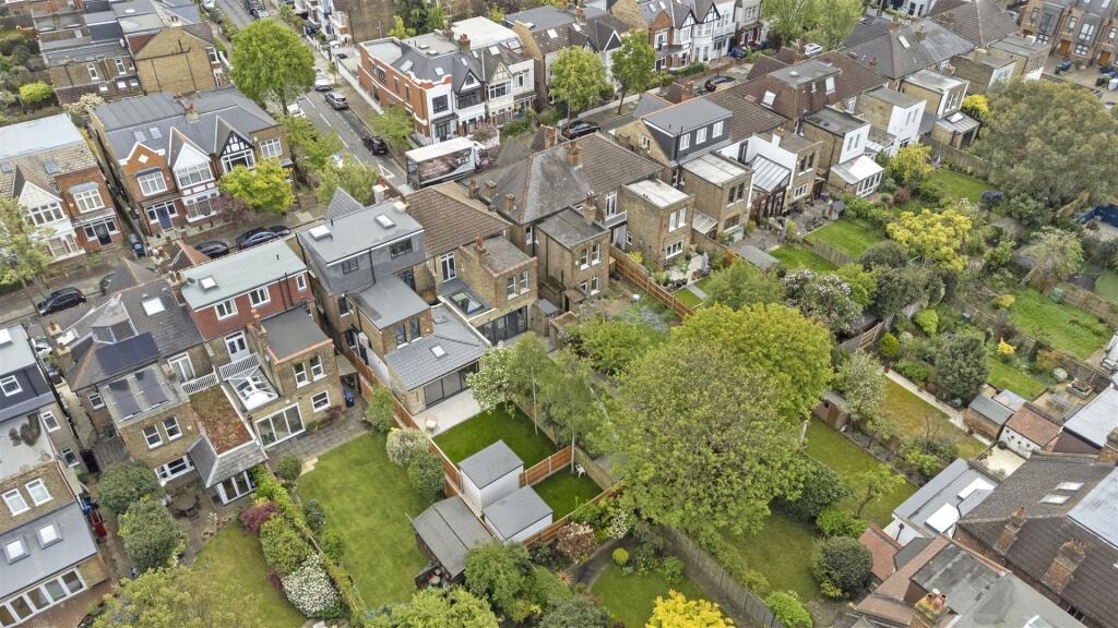 High aerial view showing rear garden, garden studio and surrounding neighbourhood