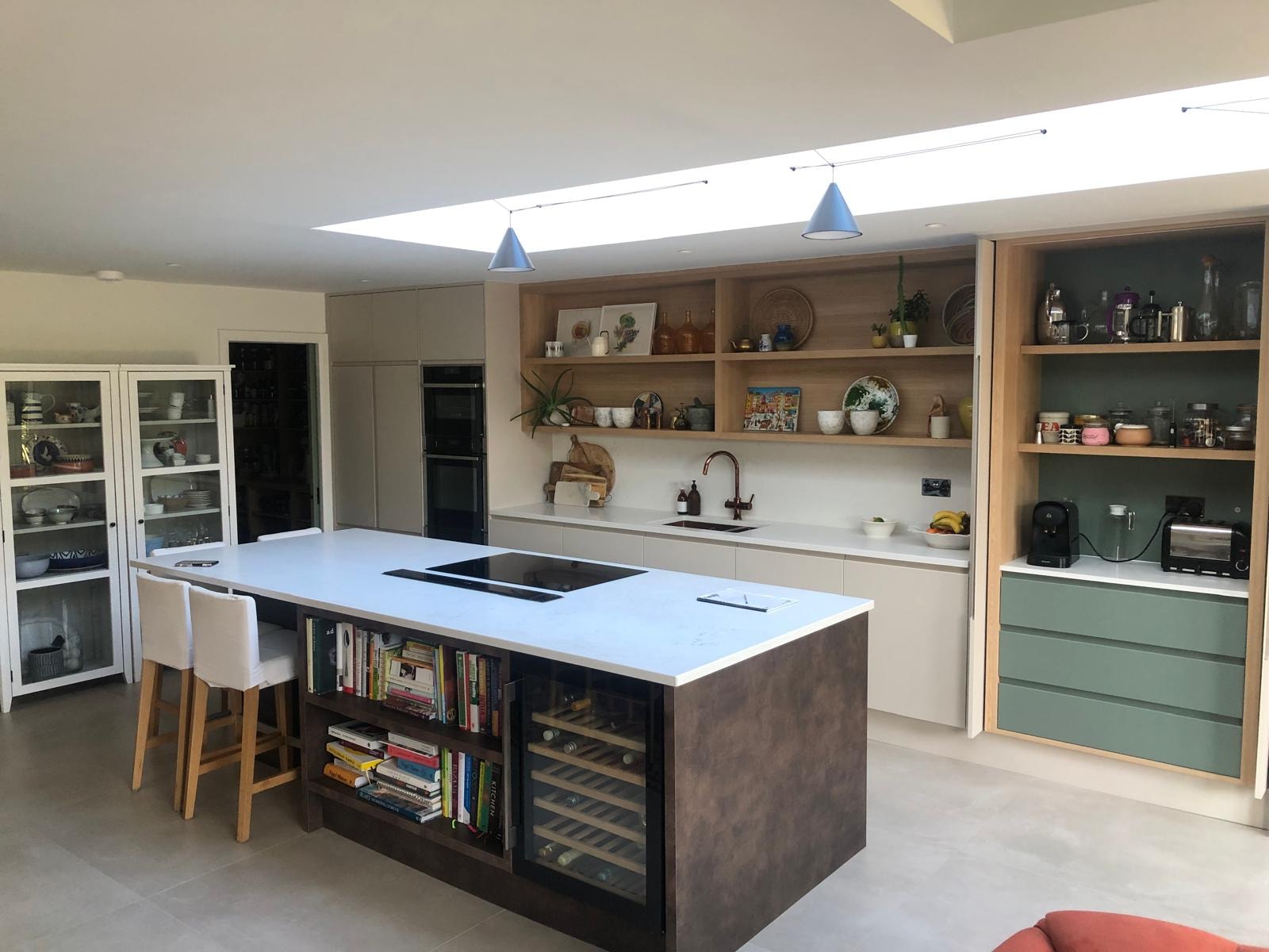 Love Lane — kitchen with sage green cabinetry, open shelving and roof lantern above