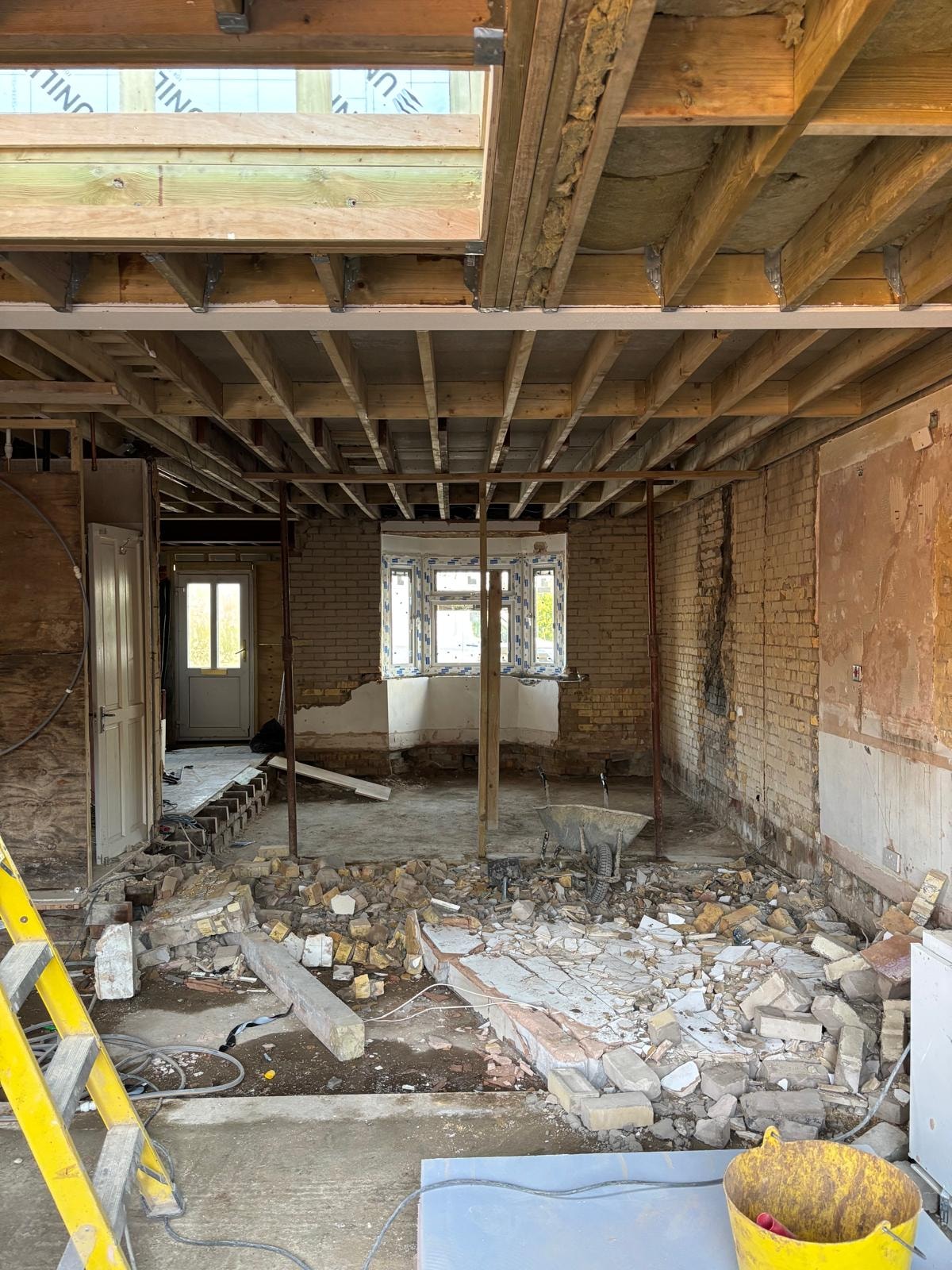Pursley Road — interior demolition phase with walls stripped back to brick, floor joists exposed and structural steels visible