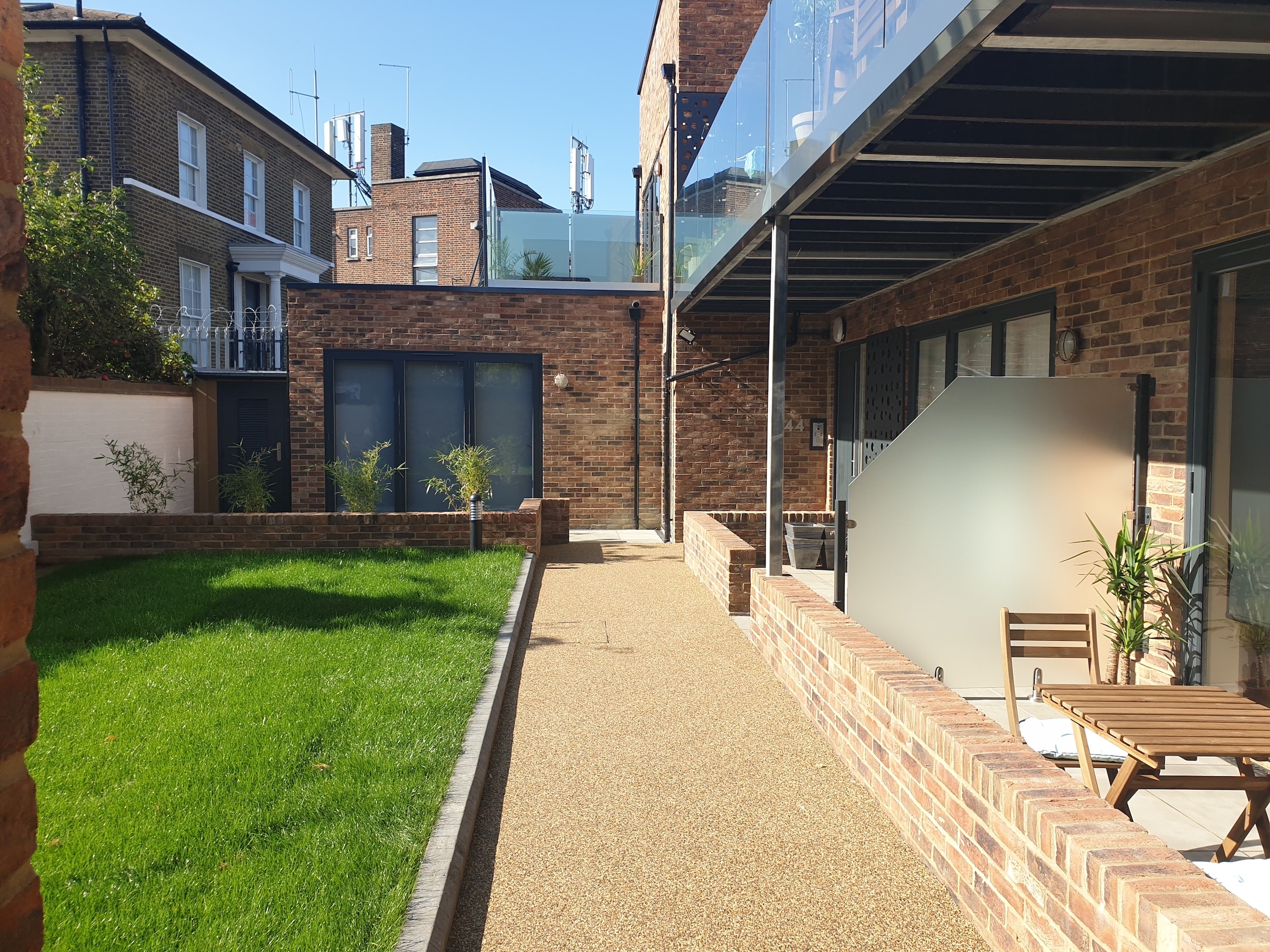 Upper Tulse Hill — completed rear courtyard with landscaped lawn, resin path and ground floor terrace