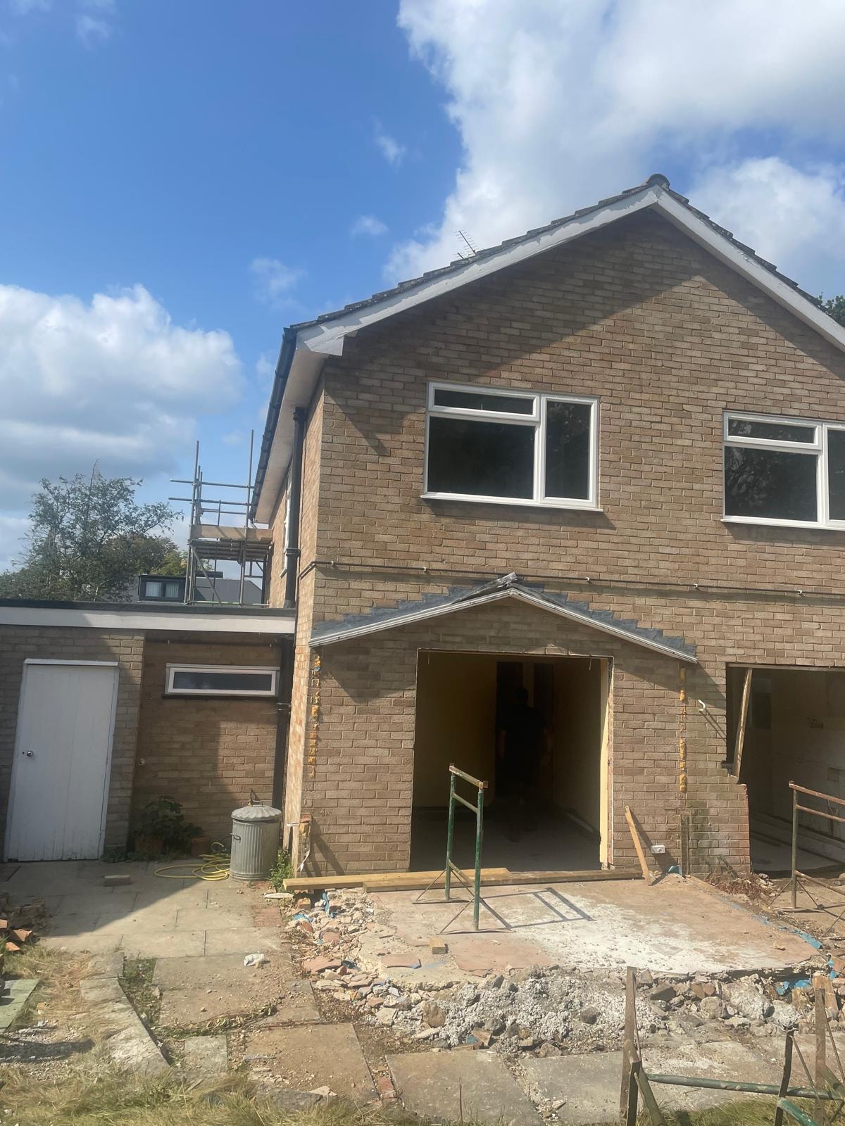 3 Warburton Close — existing property before works, original brick construction with rear demolition underway