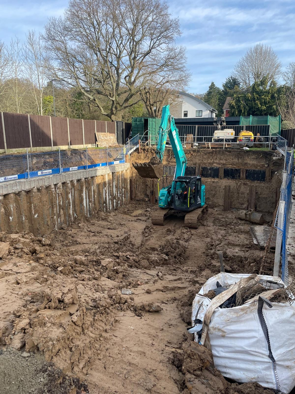 Bellfield Avenue — basement excavation showing sheet pile retaining walls and groundworks in progress