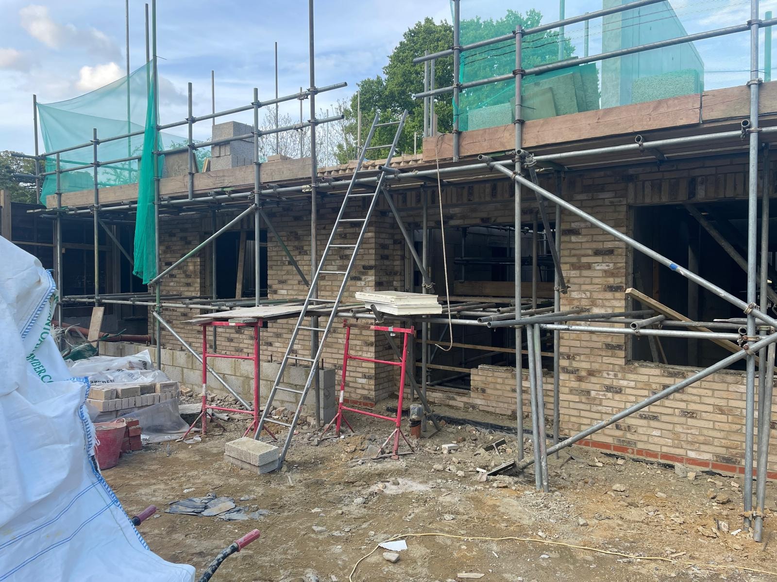 Bellfield Avenue — ground floor brickwork rising under scaffolding with loft structure forming above