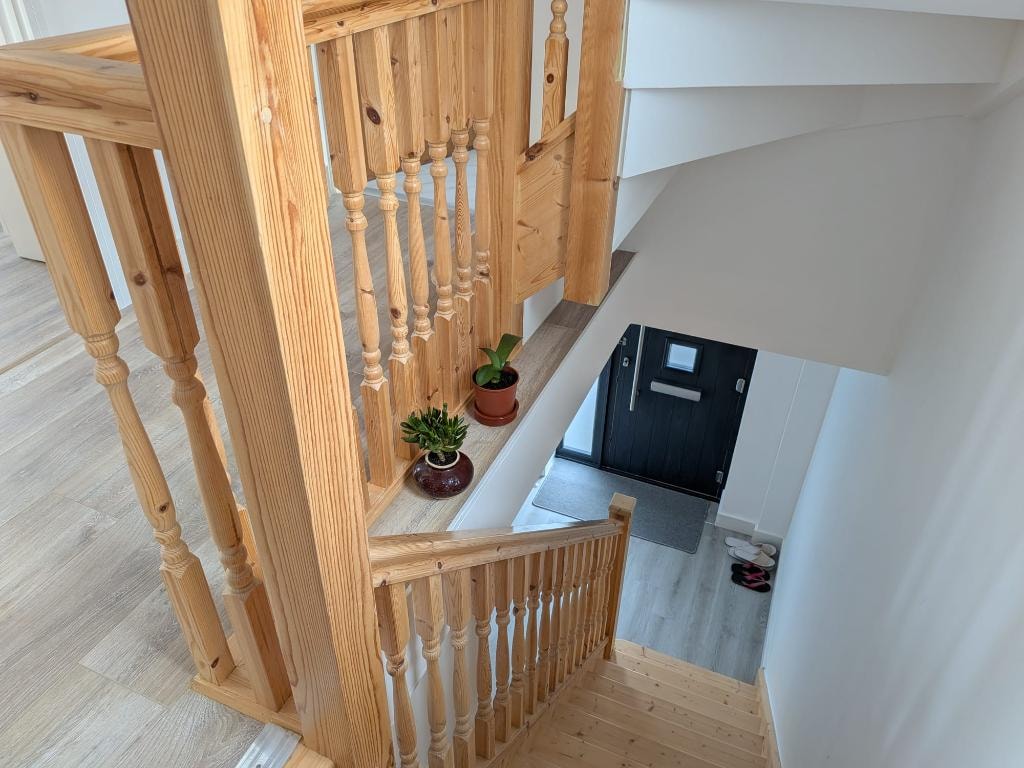 Orchard Gate — staircase with natural timber balustrade and entrance hall below