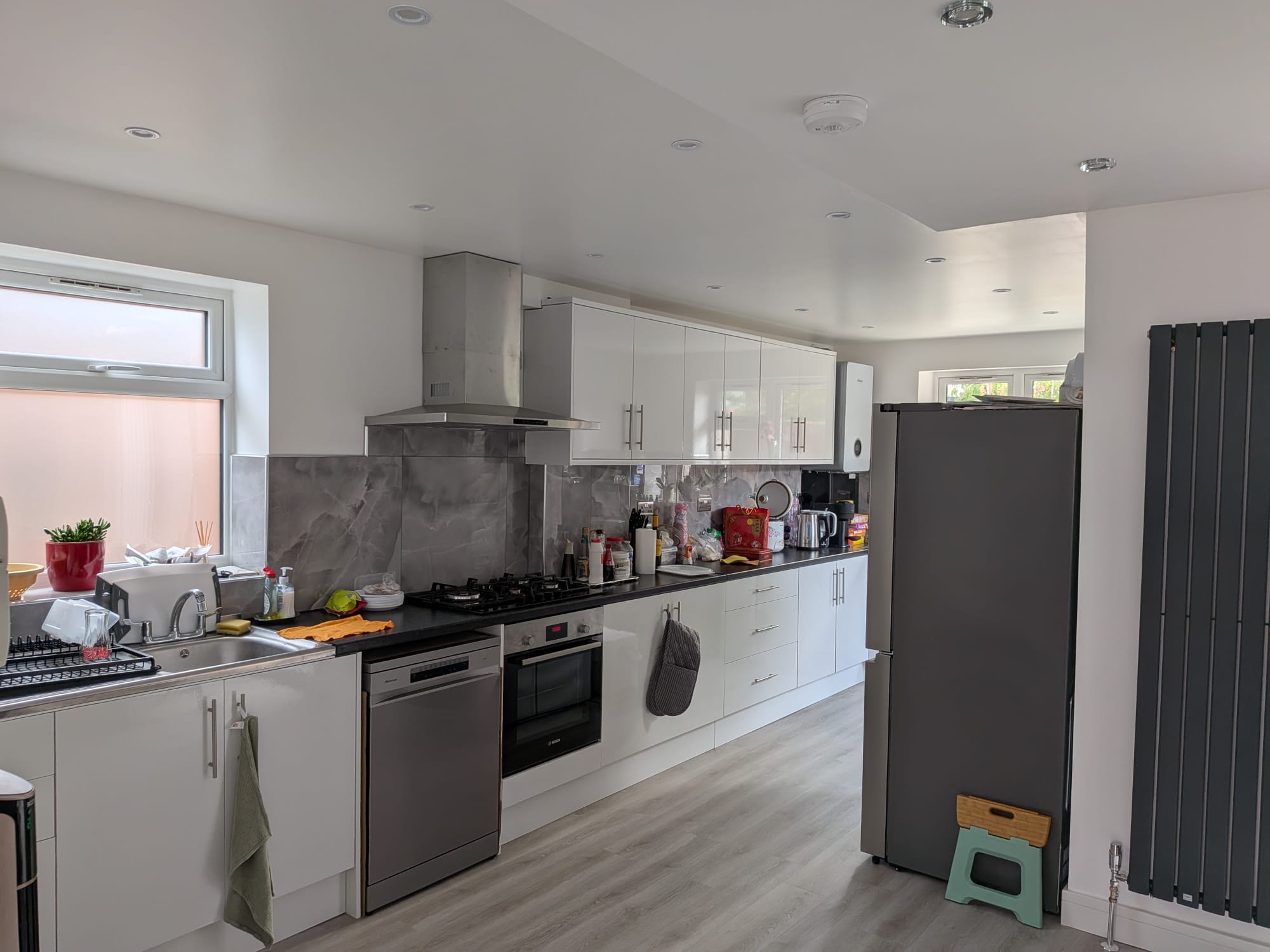 Orchard Gate — contemporary kitchen with white gloss units and marble splashback