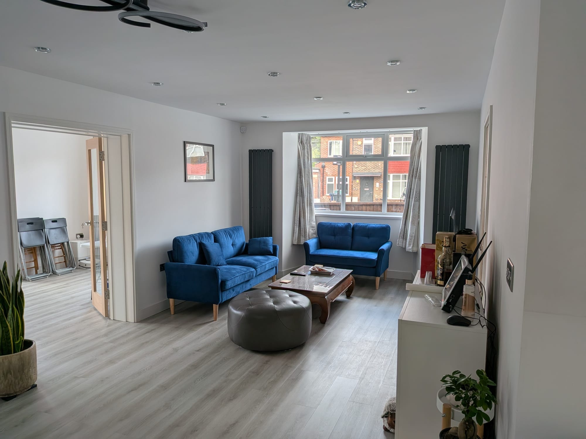 Orchard Gate — living room with blue sofas and open-plan layout